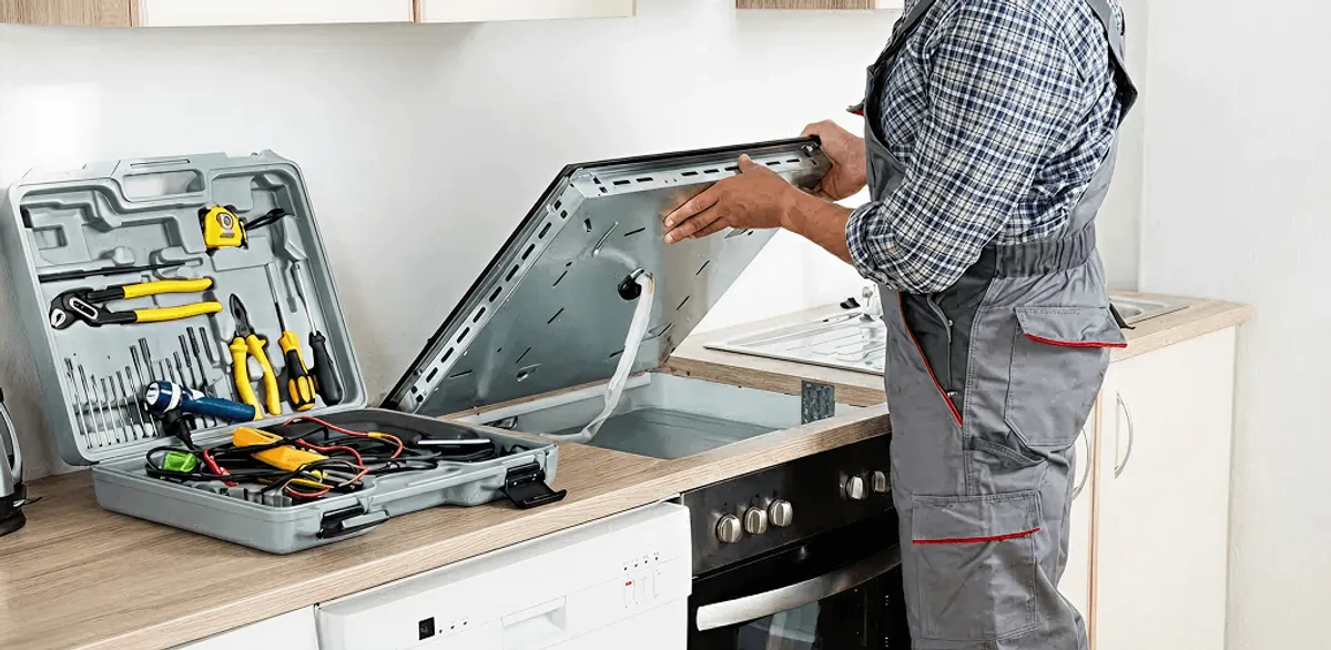 Handyman repairing a cooktop and checking wiring connections in Jacksonville, FL