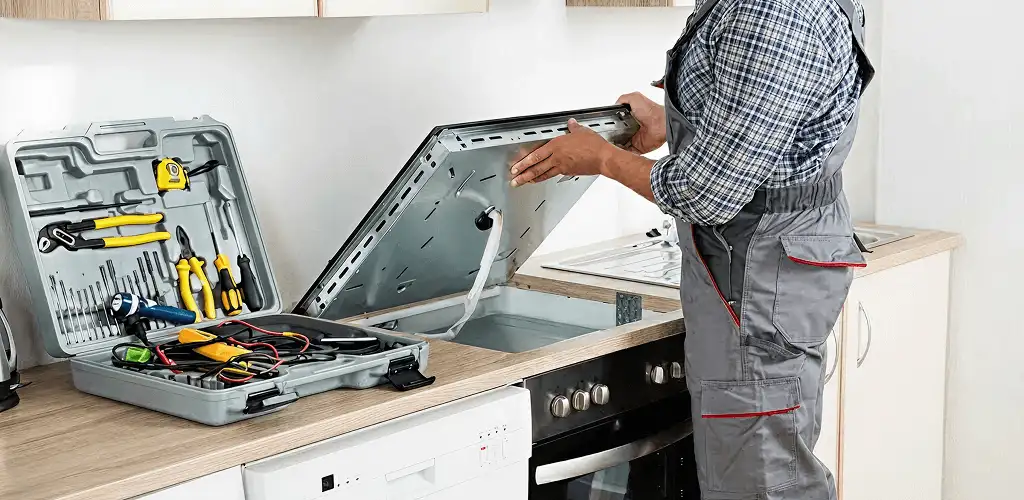 Handyman repairing a cooktop and checking wiring connections in Jacksonville, FL