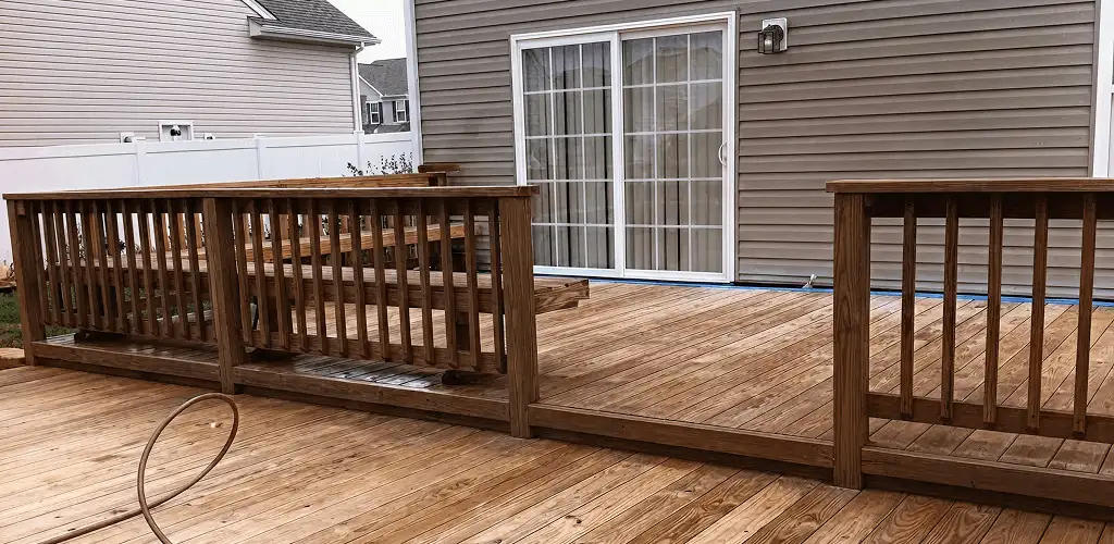 Deck sealing service protecting a backyard wood deck and railings in Jacksonville, FL