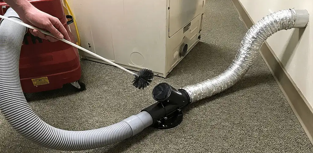 Dryer vent cleaning service removing lint from a dryer duct connection in Jacksonville, FL