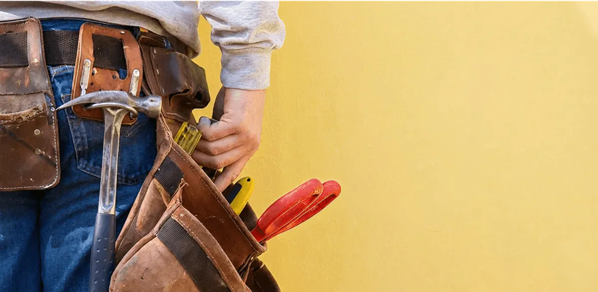 Handyman with tool belt ready for home repairs and maintenance in Jacksonville, FL