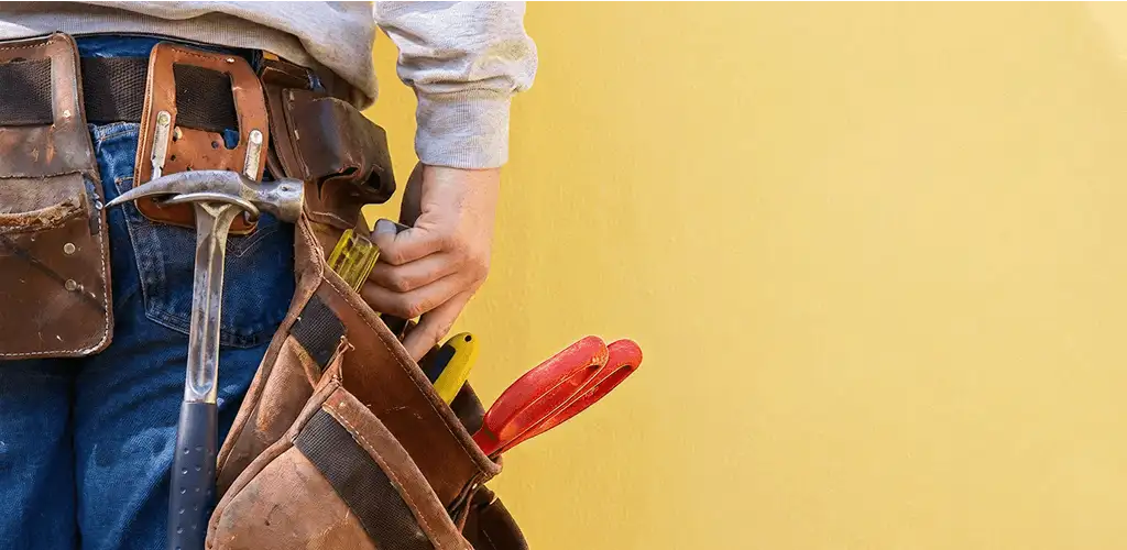 Handyman with tool belt ready for home repairs and maintenance in Jacksonville, FL