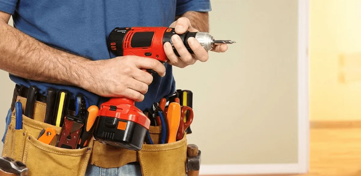 Handyman holding a power drill for home repairs and installations in Jacksonville, FL
