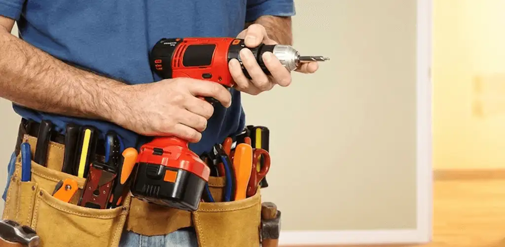 Handyman holding a power drill for home repairs and installations in Jacksonville, FL