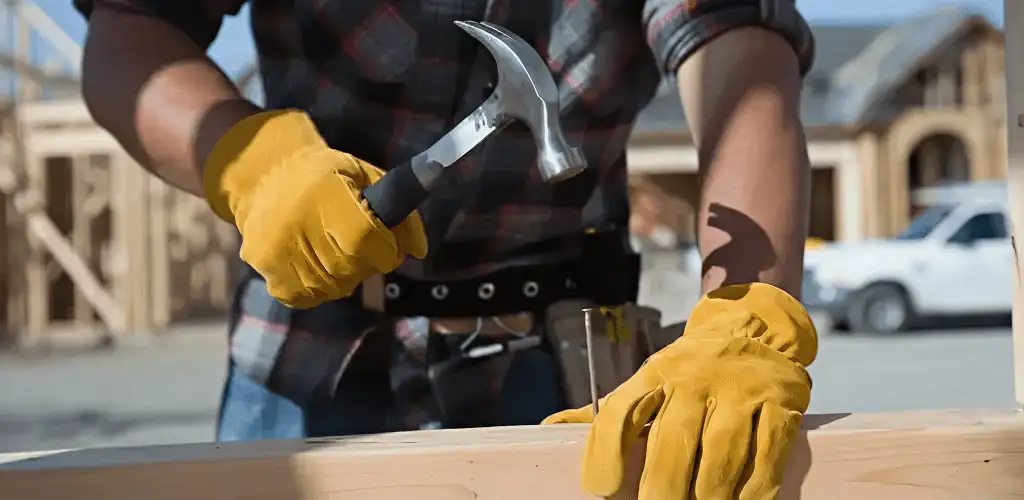 Handyman fixing wood trim with a hammer for home repairs in Jacksonville, FL