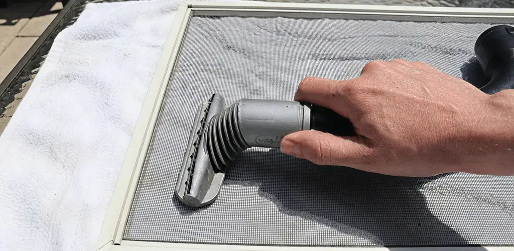 Window screen repair cleaning and fixing a damaged screen mesh in Jacksonville, FL